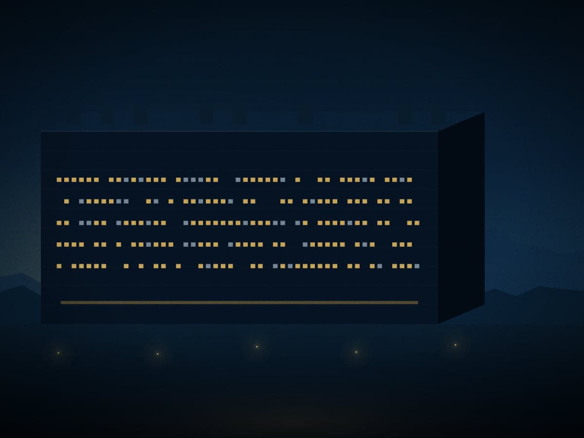 An operating data hall with lit facade bands at dusk.
